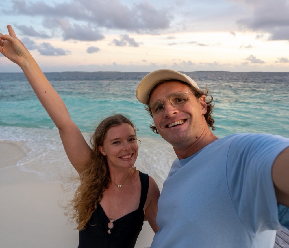 Rhett and Claire on a beach at sunset