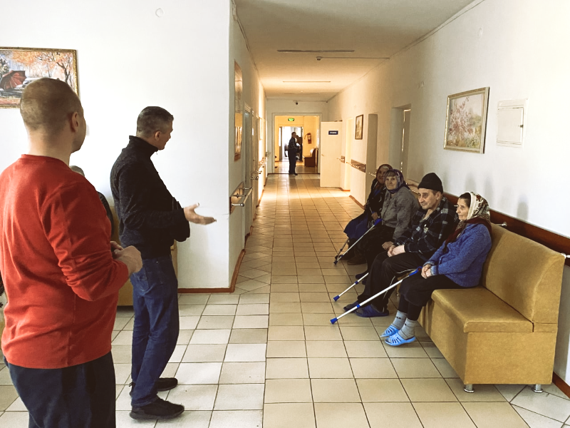 Brothers ministering at a nursing home after delivering necessities.