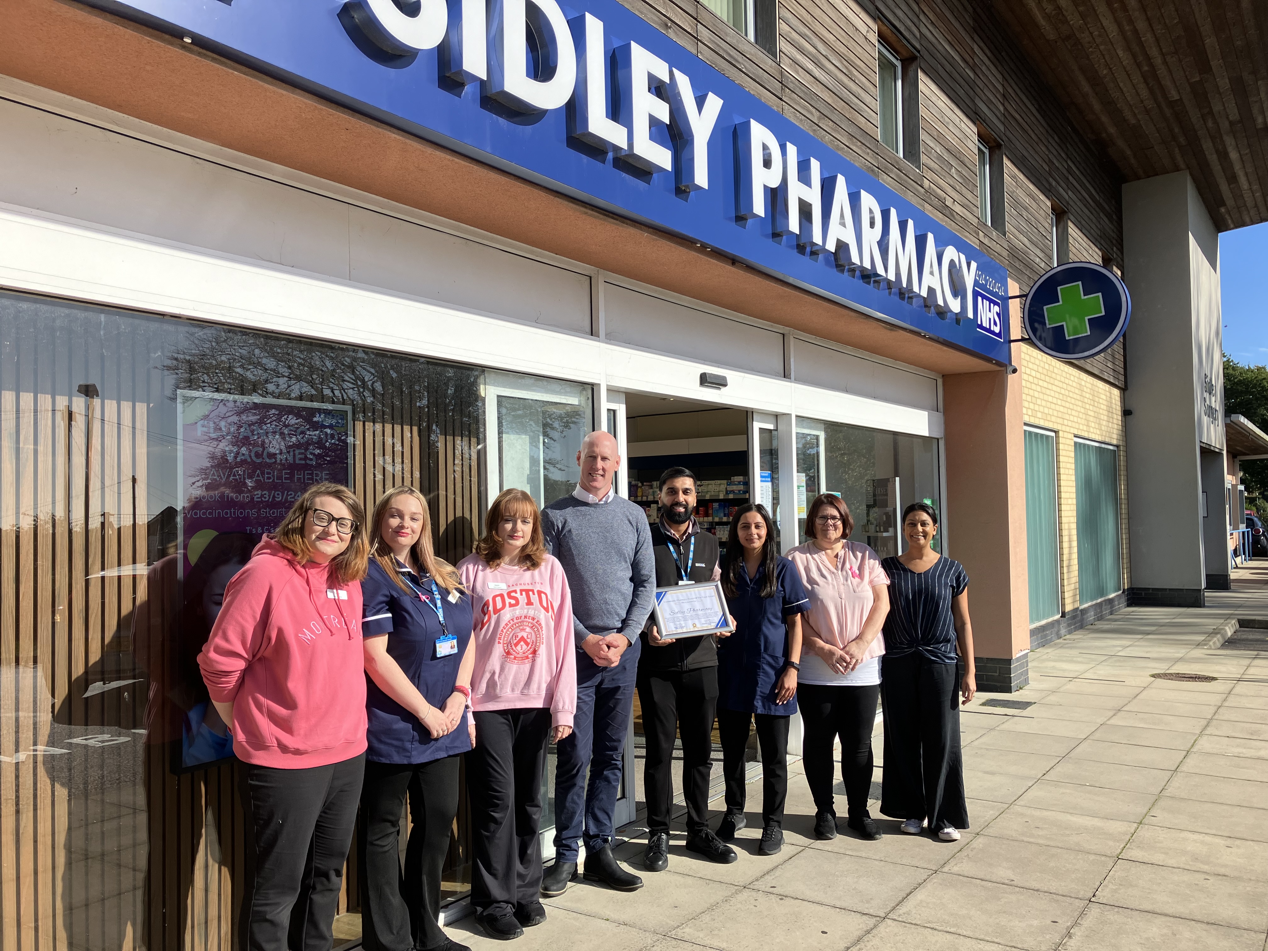 Kieran at Sidley Pharmacy with staff