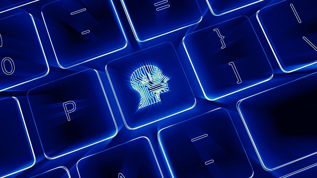 Imagem ilustrativa mostra um desenho de um cérebro com a palavra AI inserido em um teclado de computador