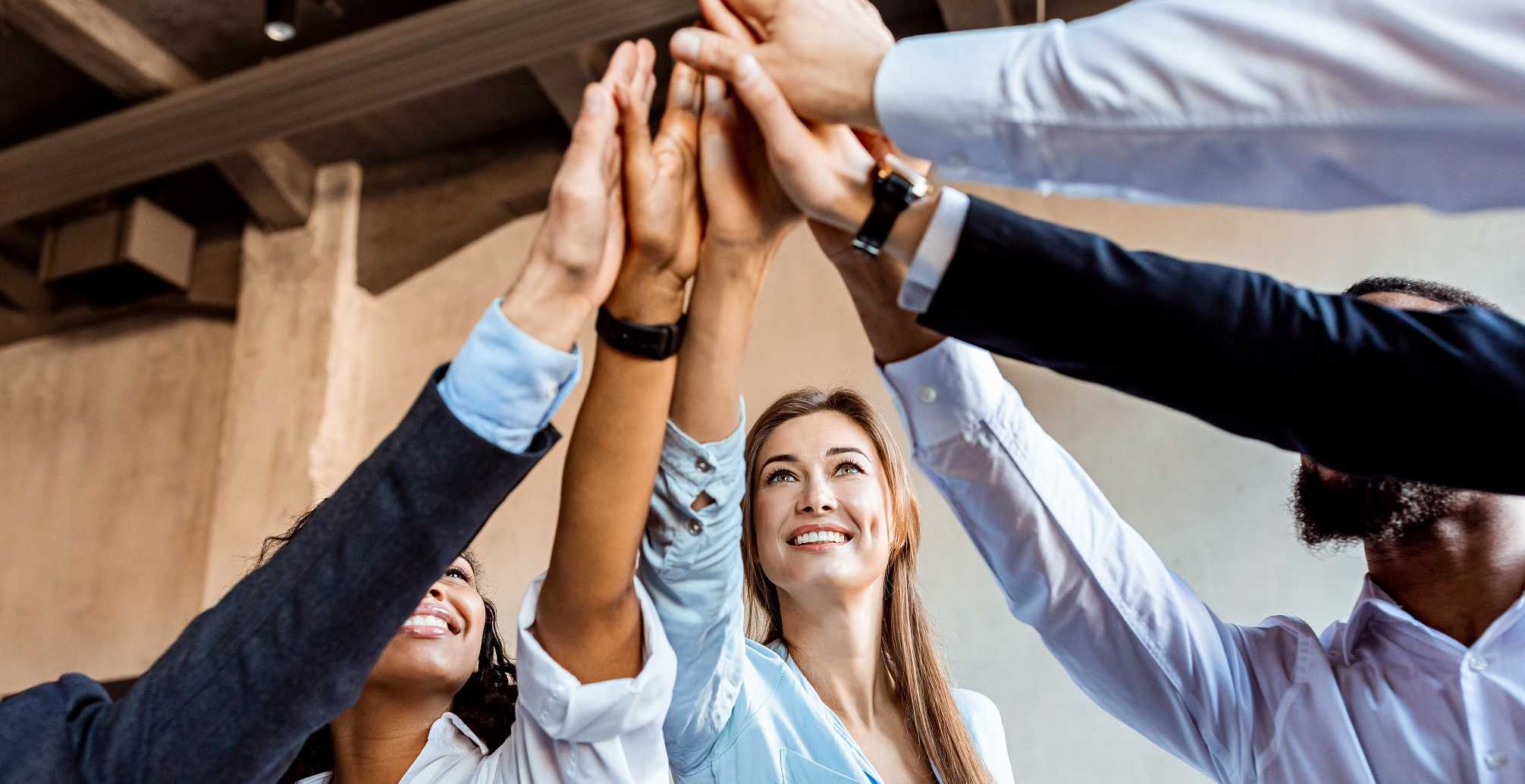 Joyful Team Of Coworkers Giving High-Five Celebrating Deal In Office, photo: Prostock-studio - stock.adobe.com