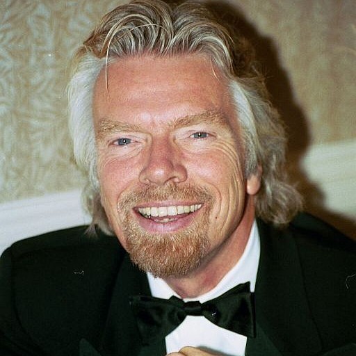 Richard branson in a suit smiling