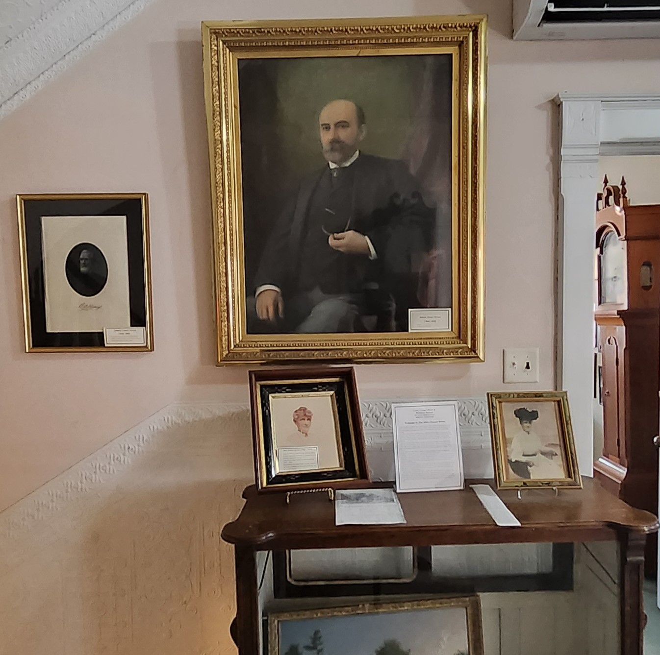 Small portrait of Edward Crouch Humes (left). Large portrait of William Potter Humes (top right). Two portraits of Ann Elmira Humes (bottom right). These images are on a wall inside the Miles-Humes House right after the main staircase opening to the second floor.