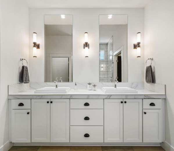 Bright primary suite with a double vanity and walk-in shower