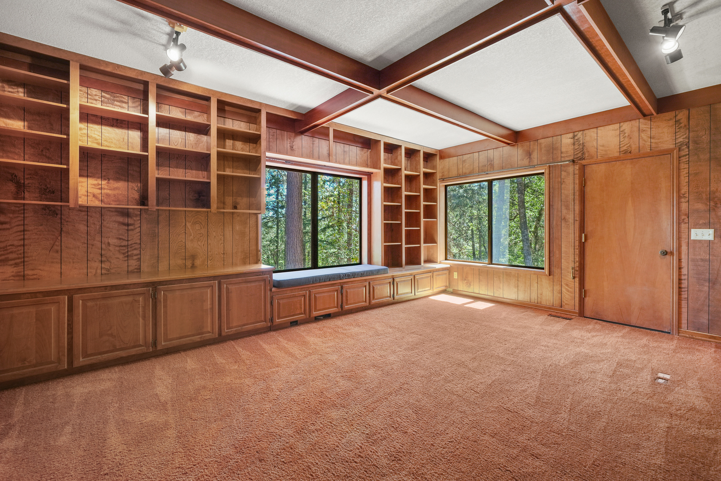Home library and office with wood built-ins and decorative beams
