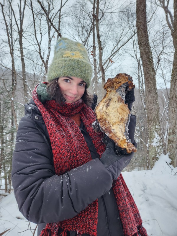 Maria holding up a chaga like a baby